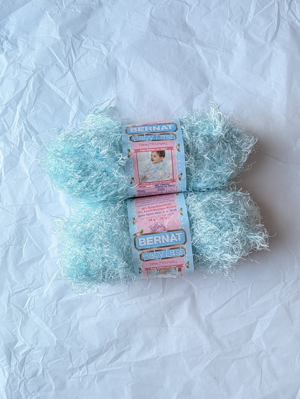 2 skeins Bernat Baby Lash yarn in the color 'gentle green'